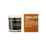 Malin + Goetz Glassed Leather Candle beside brown packaging box 