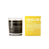 Malin + Goetz Glassed Dark Rum Candle beside yellow Packaging box 