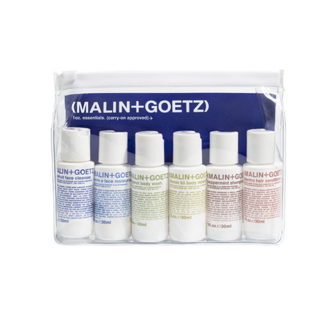 Malin + Goetz 6 30ml traveling bottles in clear bag, containing Grapefruit cleanser, Vitamin E Moisturizer, Body Wash and lotion, Peppermint Shampoo and cilantro Conditioner